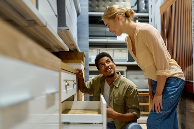 CARPINTERIA JM LOPEZ LOPEZ -  - interracial couple choosing new cabinets kitchen furniture store looking details